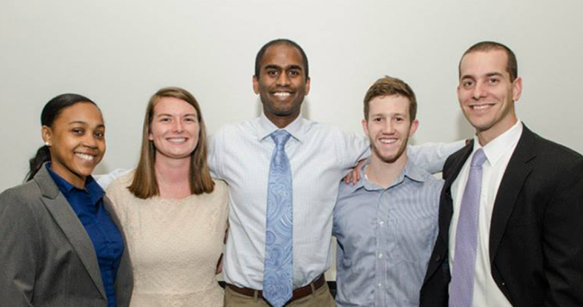 Group of alumni smiling at the camera