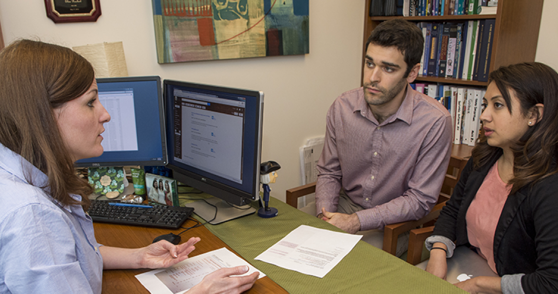 Students sitting across from an advisor in an office