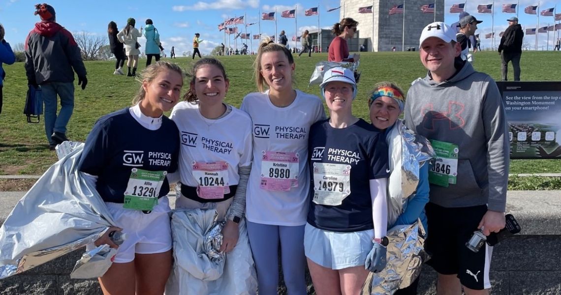 Students and faculy post race in front of the Washington Monument