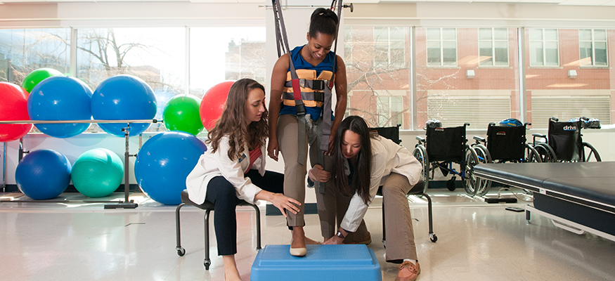 Physical therapists in a clinic working with a patient