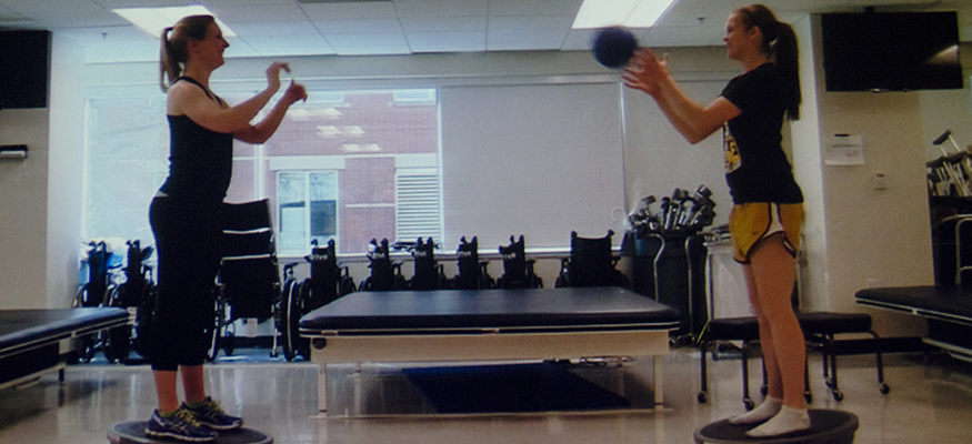 Follies - students in a PT clinic throwing a ball to each other