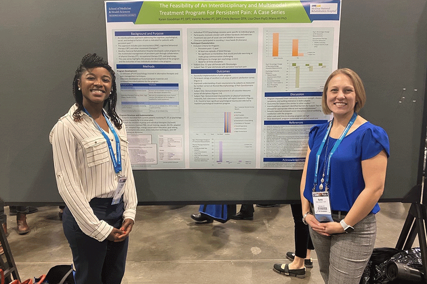 two women standing in front of a poster of a scientific study
