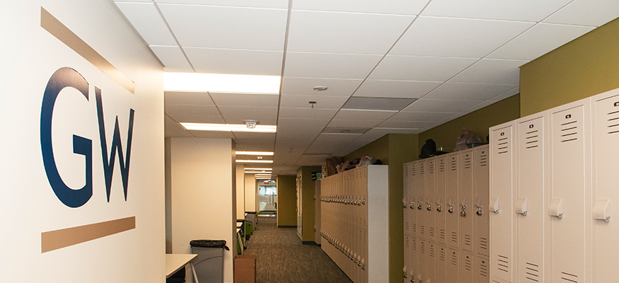 hallway with lockers and the "GW" logo on the wall