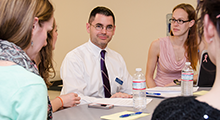 Students sitting around a table at a meeting
